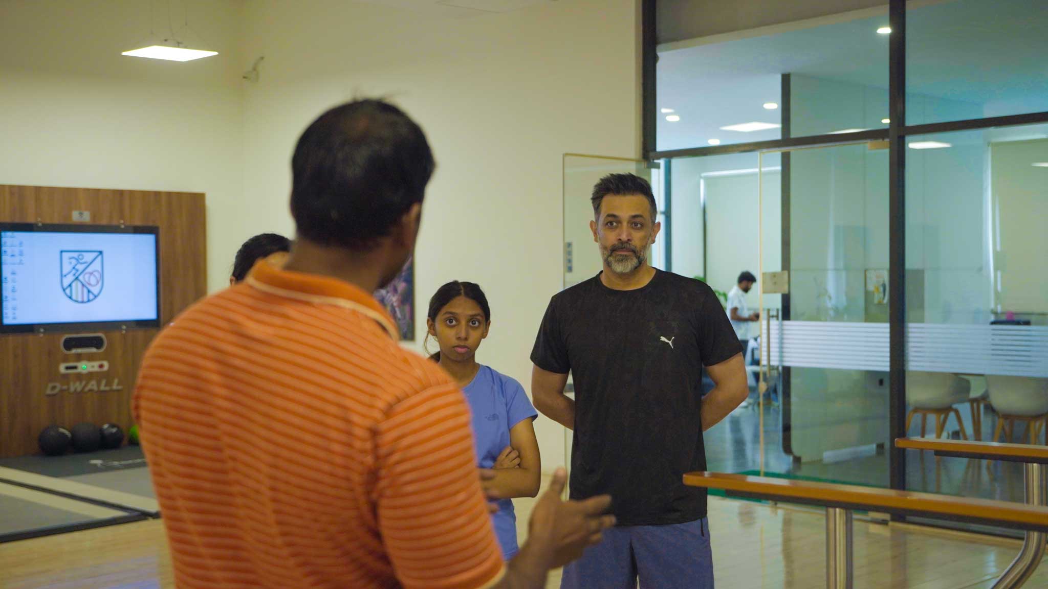 Family listening to trainer in fitness center